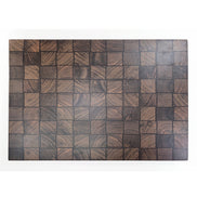 A rectangular wooden board or tray featuring a basket weave pattern of square wood blocks with varied dark brown and black grain textures, shown against a plain white background.