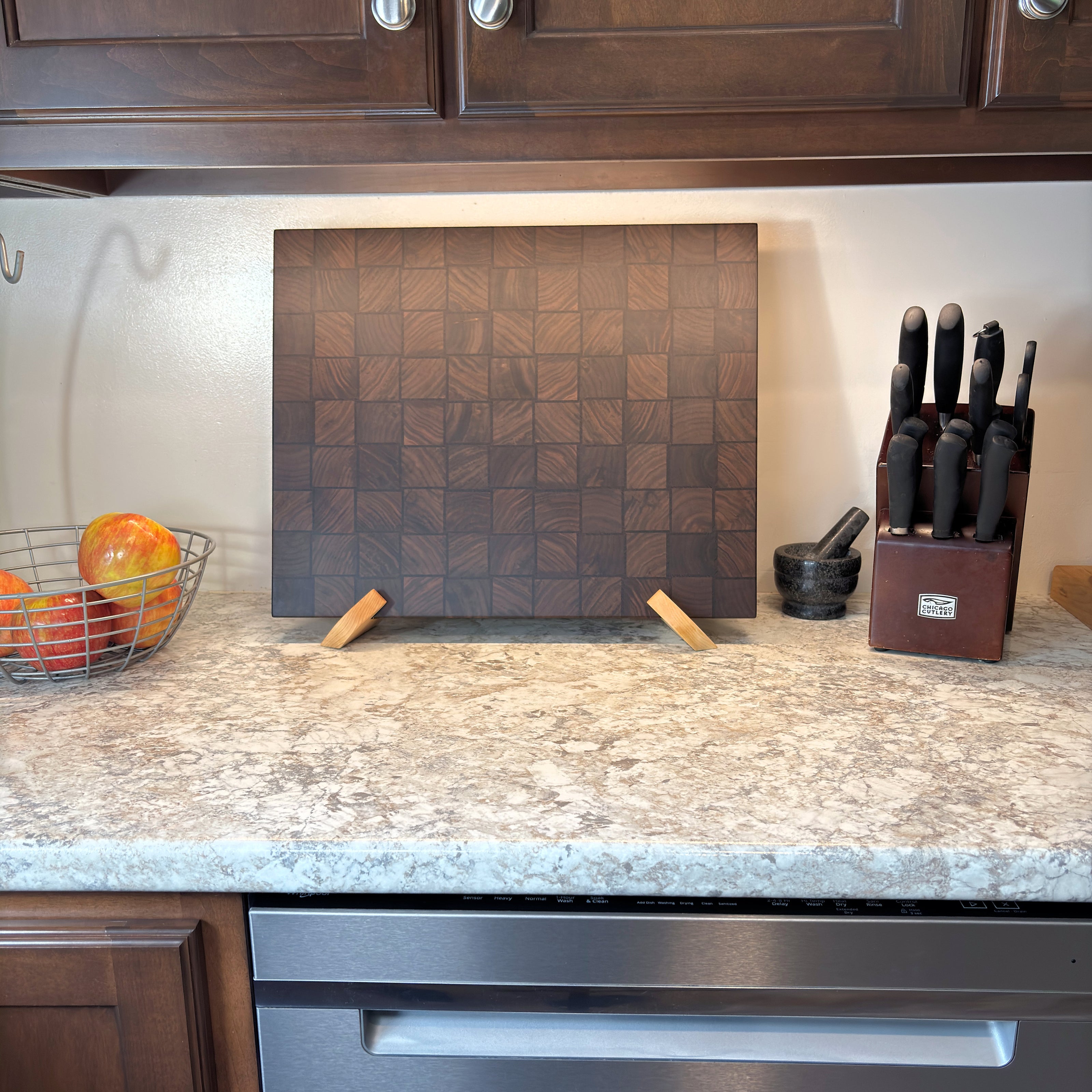 Handcrafted basket weave end grain cutting board in black walnut and wenge, standing upright